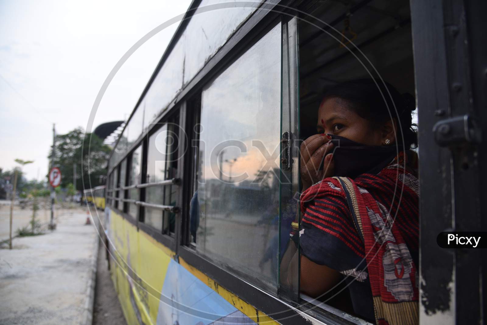 Migrant woman worker waits in a bus after registering from Cyberabad Police to get onto a Shramik Special Train during ongoing Nationwide Lockdown amid Coronavirus Pandemic, Kukatpally,Hyderabad, May 19,2020.