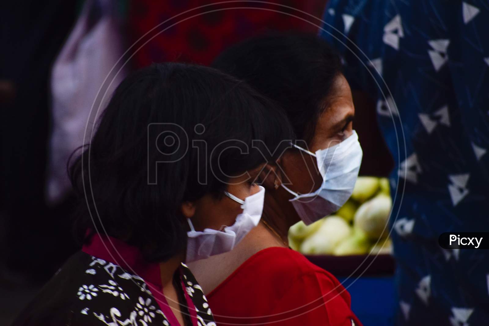 People wearing medical mask as safety, prevention and protection from Covid 19 Corona Virus at market place in lockdown 4. Men's and women's with children and old buying and selling vegetables. Crowded public place. No social distancing. Covid 19 Corona Virus pandemic.