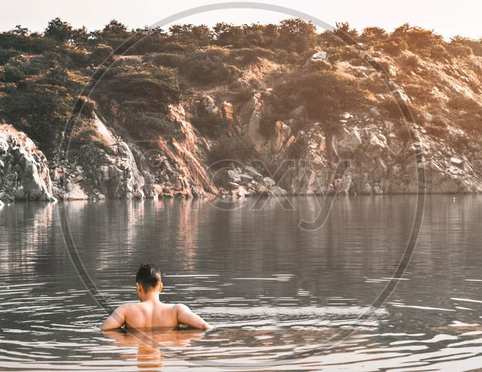 boy swimming in a lake