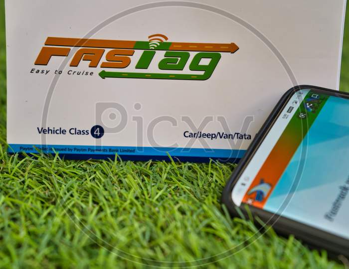 Fast Tag On Green Grass With A Mobile Phone Logged Into Fast Tag Website.