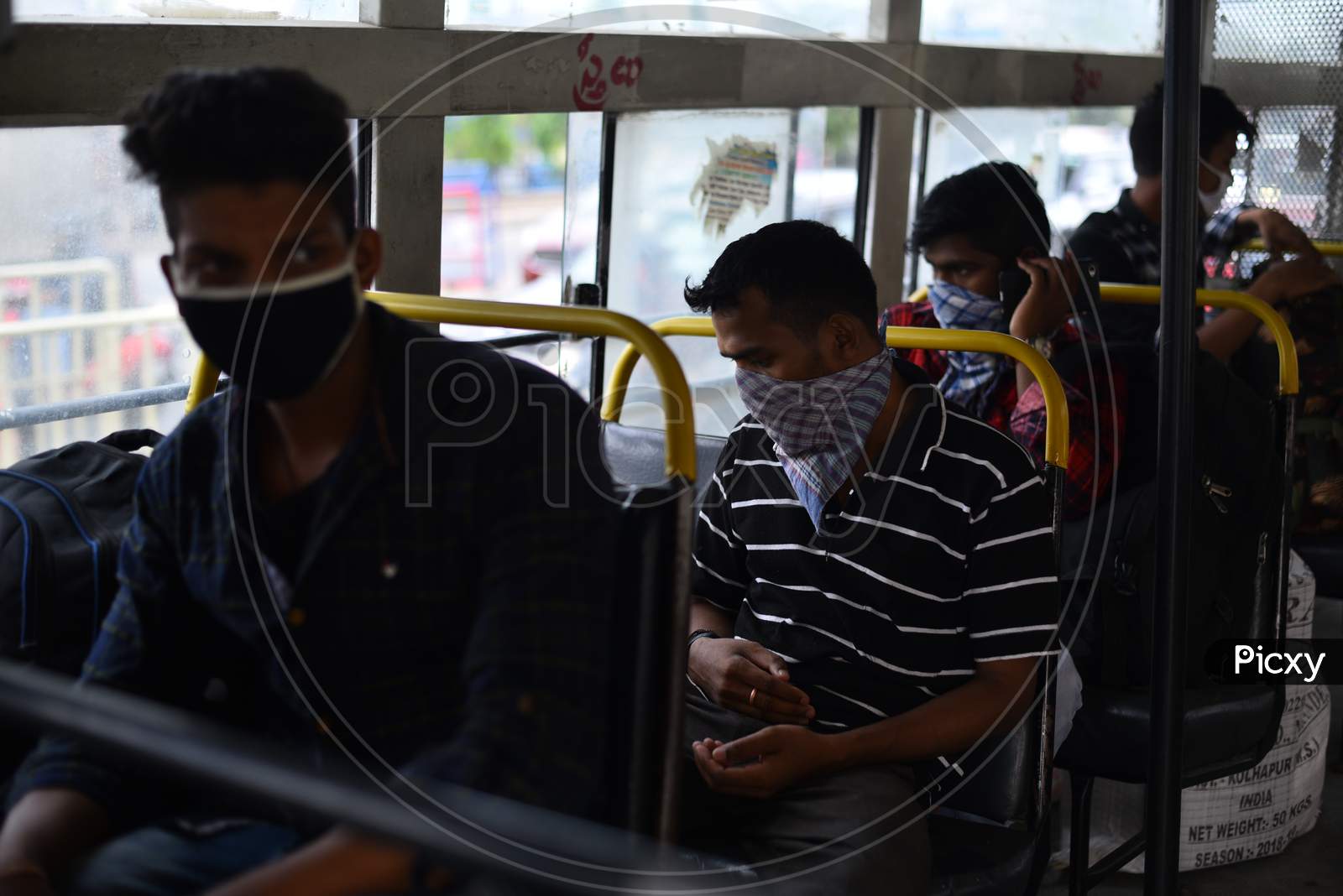 Migrant Workers from Bihar, Jharkhand and UP get into a bus after registering from Cyberabad Police to get onto a Shramik Special Train during ongoing Nationwide Lockdown amid Coronavirus Pandemic, Kukatpally,Hyderabad, May 19,2020.
