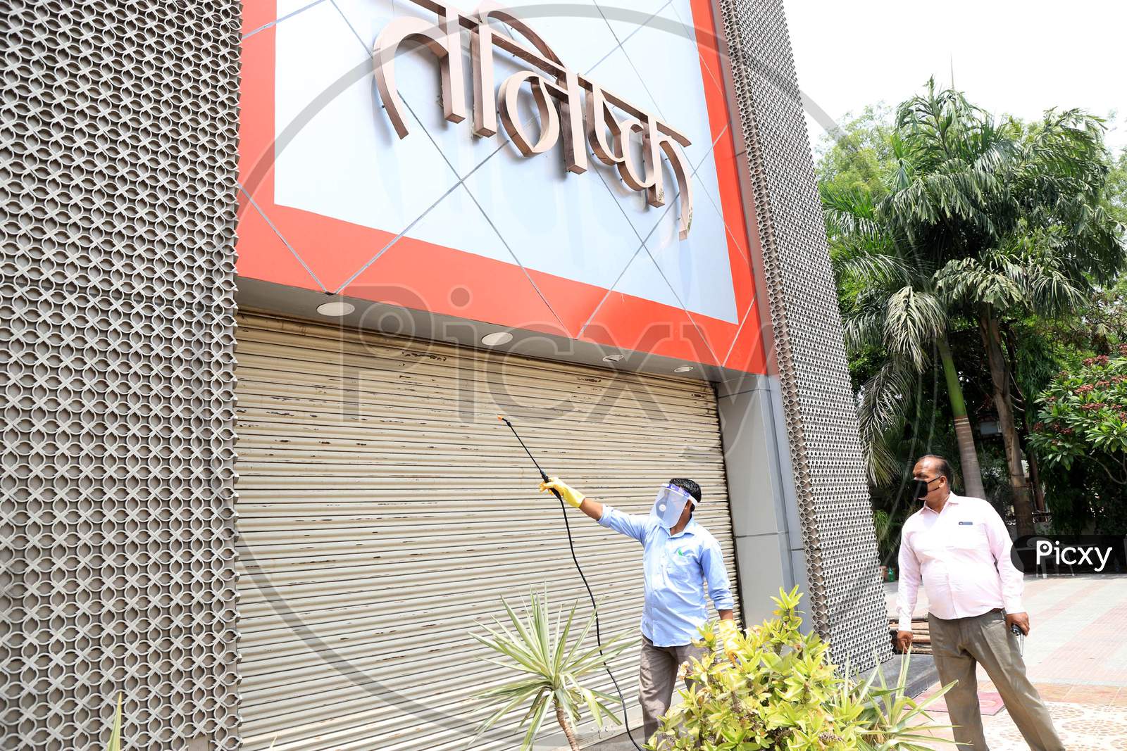 Workers Sanitise The Shop  After  Authorities Allowed Shopkeepers To Open Their Establishments With Certain Restrictions During Coronavirus or COVID-19 Pandemic in Prayagraj, May 20,2020