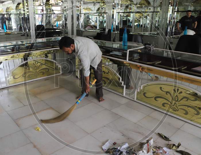 A Worker Cleans The Shop  After  Authorities Allowed Shopkeepers To Open Their Establishments With Certain Restrictions During Coronavirus or COVID-19 Pandemic in Prayagraj, May 20,2020