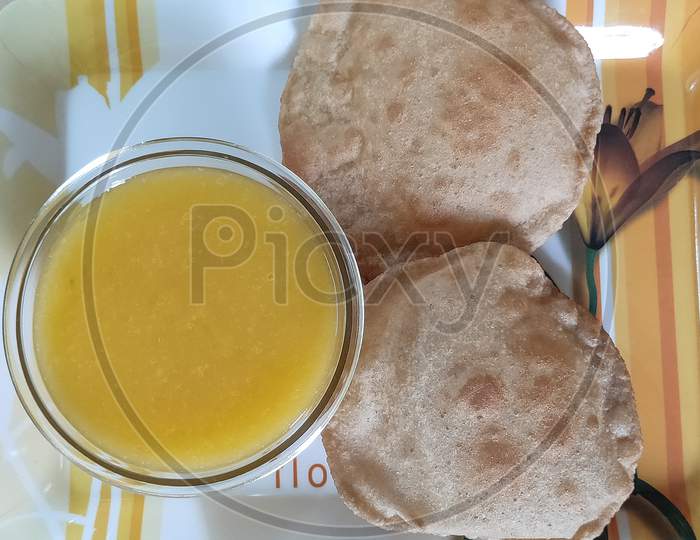 Mango juice and Puri dish. Poori and mango juice in a plate.