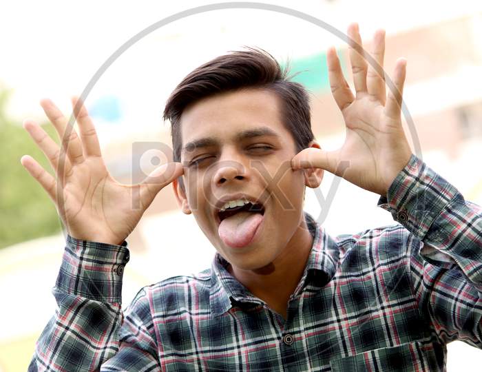 funny guy portrait, teen age Asian boy open mouth with crazy style, selective focus.