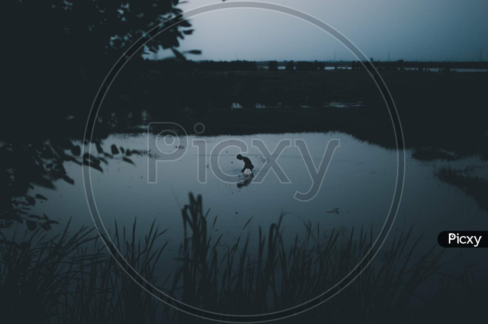 A fisherman in a pond