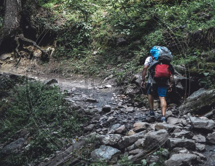 a boy hiking with two bags