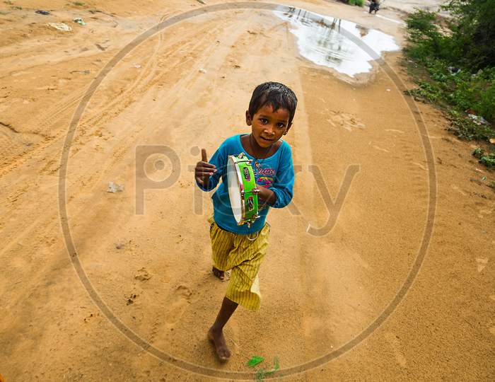 Hyderabad, India - June 18Th, 2019: Poor Helpless Beggar Boy Running And Begs For Food And Money From Tourist, Poverty Is A Major Issue In India.
