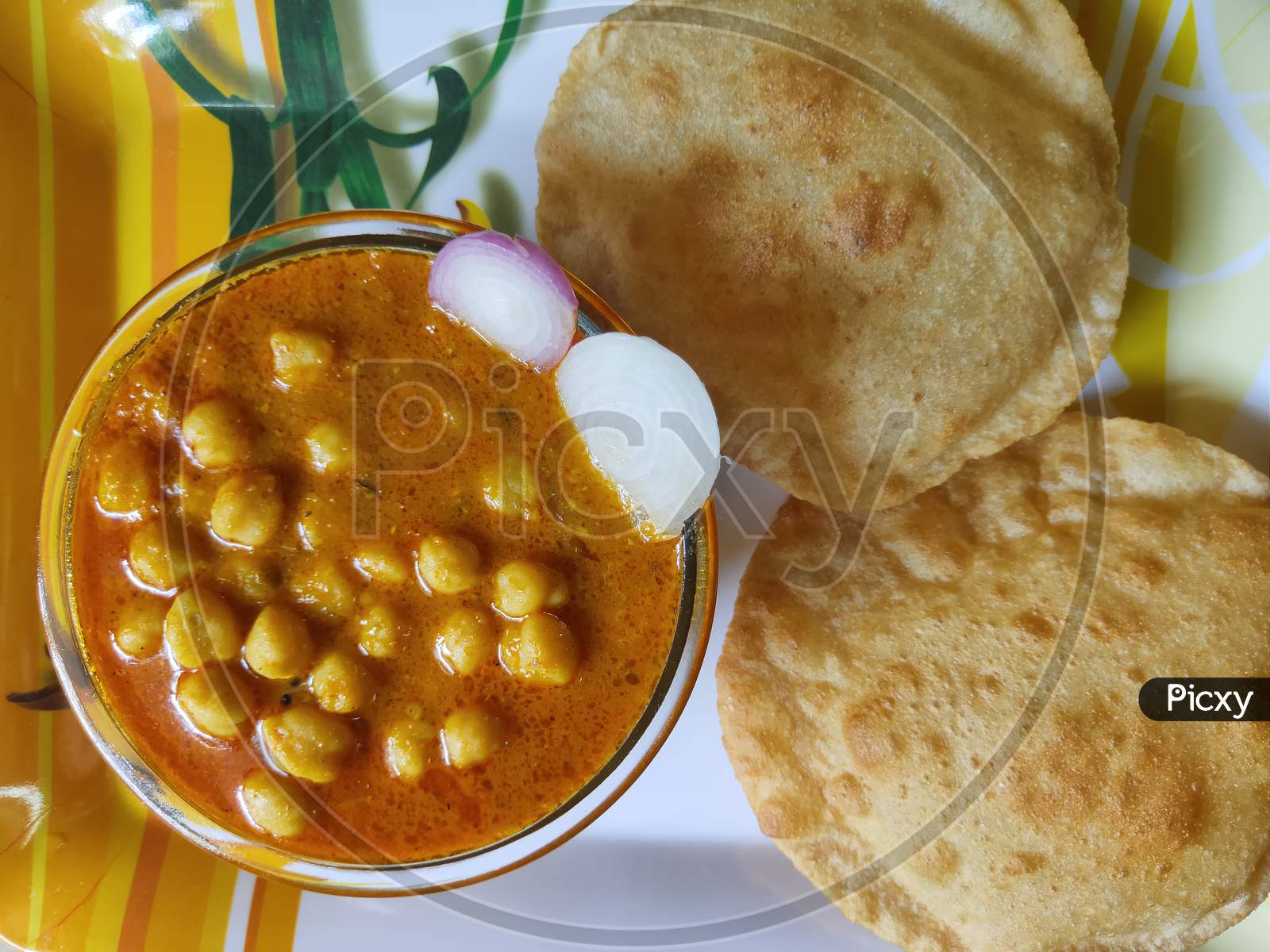 Chole Poori dish. Chickpeas receipe and Poori. Chana masala receipe and Puri in a plate.