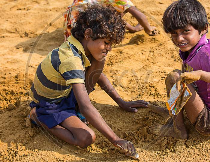 Jodhpur, Rajasthan, India - June 18Th, 2019: Poor Rural Kids Playing With Sand In Hot Summer, Unprivileged Indian Children.