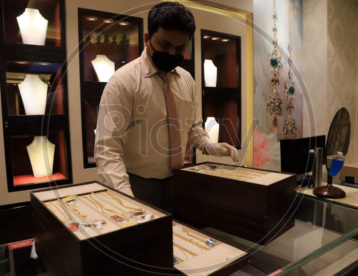 A Sales Man Arranges Jewellery At A Shop After  Authorities Allowed Shopkeepers To Open Their Establishments With Certain Restrictions During Coronavirus or COVID-19 Pandemic in Prayagraj, May 20,2020