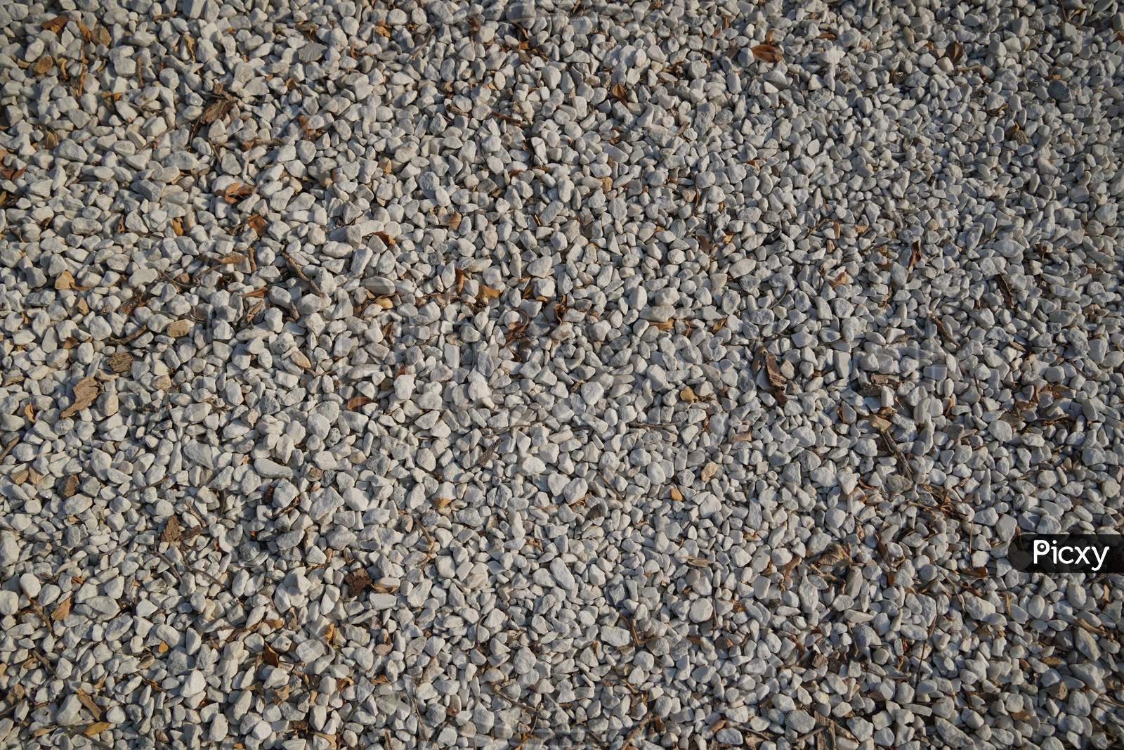 White And Brown Pebble Stone Texture For Background. The Texture Of Brown Gravel Stones.