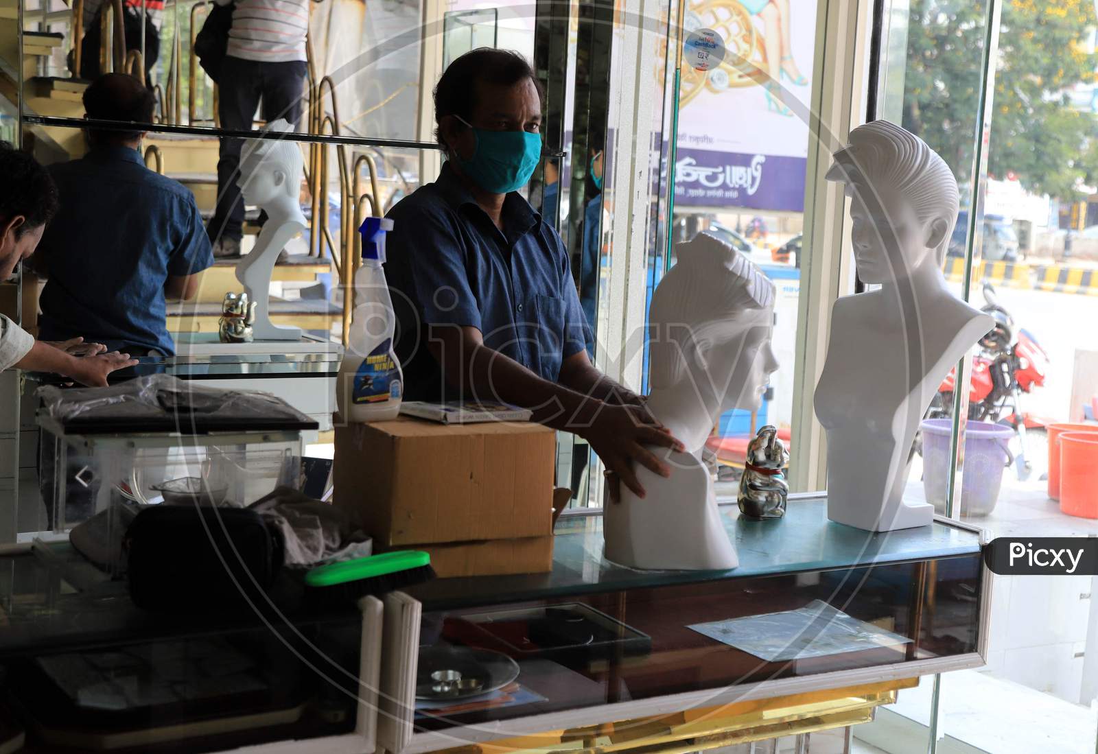 A Worker Cleans The Shop  After  Authorities Allowed Shopkeepers To Open Their Establishments With Certain Restrictions During Coronavirus or COVID-19 Pandemic in Prayagraj, May 20,2020