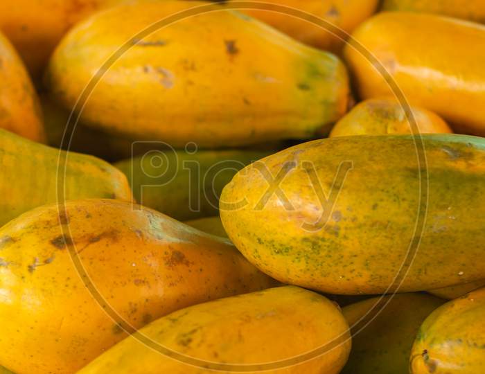 Papaya In The Market. Fruit Of Orange Pulp With Countless Small Seeds. Exotic Tropical Fruit