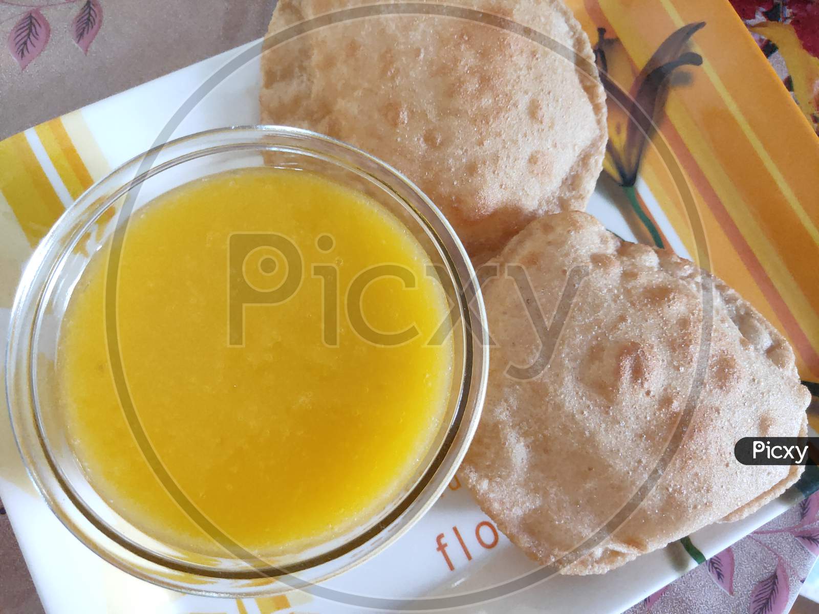 Mango juice and Puri dish. Poori and mango juice in a plate.