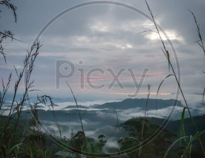 Low Clouds Above The Mountains Peak At Dawn