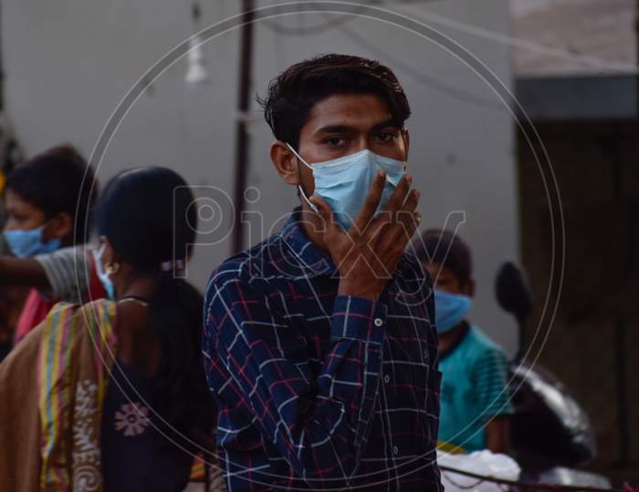 People wearing medical mask as safety, prevention and protection from Covid 19 Corona Virus at market place in lockdown 4. Men's and women's with children and old buying and selling vegetables. Crowded public place. No social distancing. Covid 19 Corona Virus pandemic.