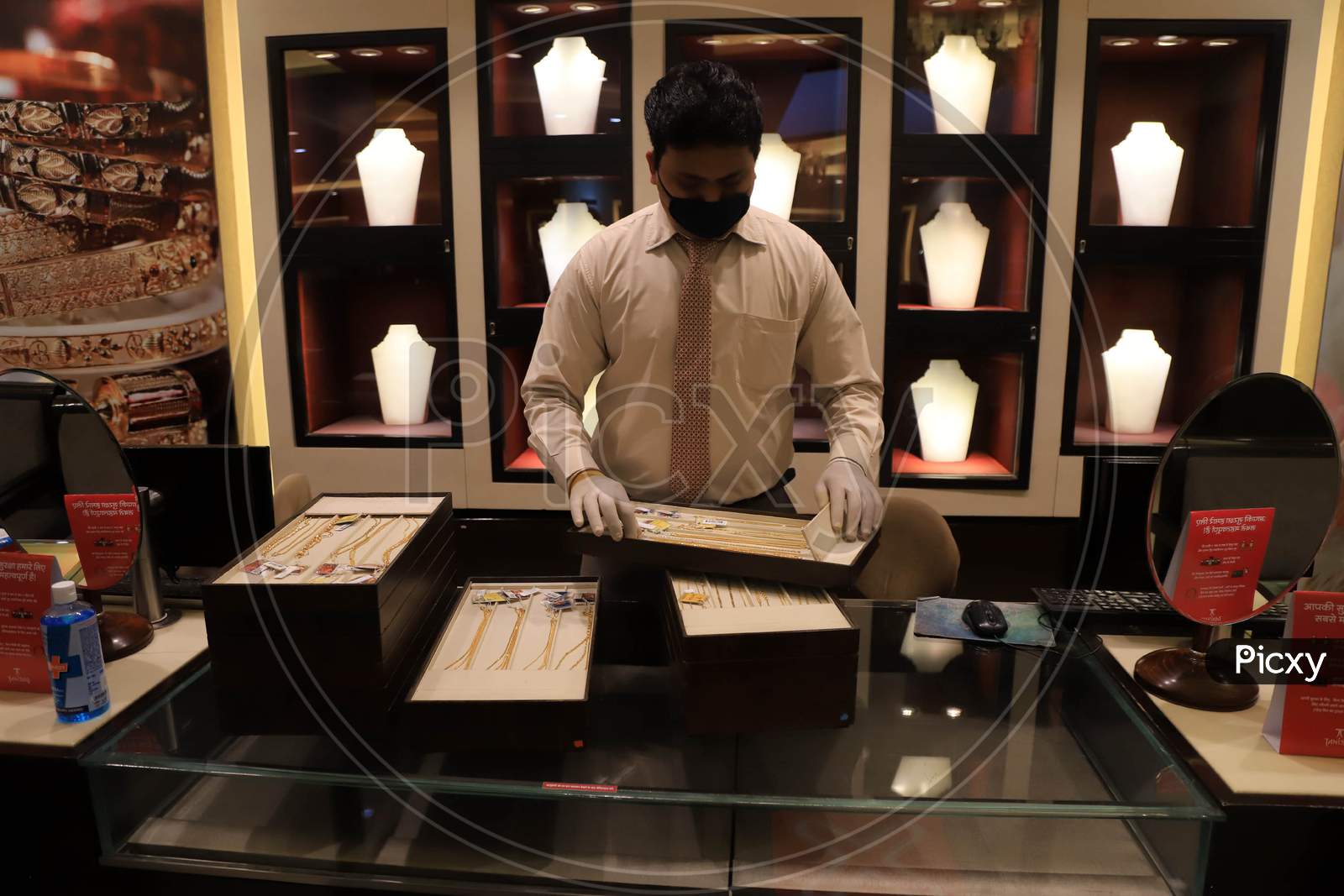 A Salesman Arranges Jewellery At A Shop After  Authorities Allowed Shopkeepers To Open Their Establishments With Certain Restrictions During Coronavirus or COVID-19 Pandemic in Prayagraj, May 20,2020