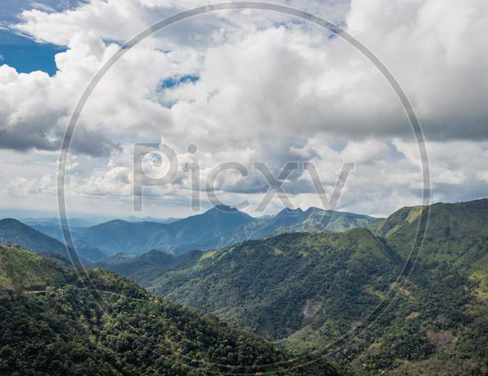 Hill Range With White Cloud And Green Forests