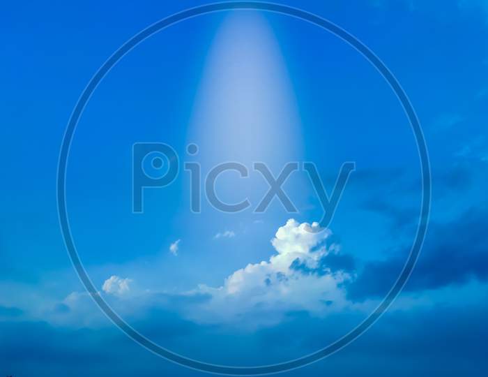 Rays of the sun touches the clouds in winter season with clear sunny blue sky and space for text
