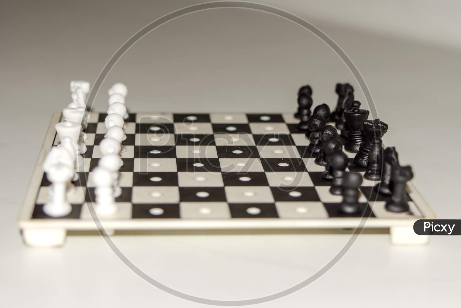 Chess board with figures on isolate white background.