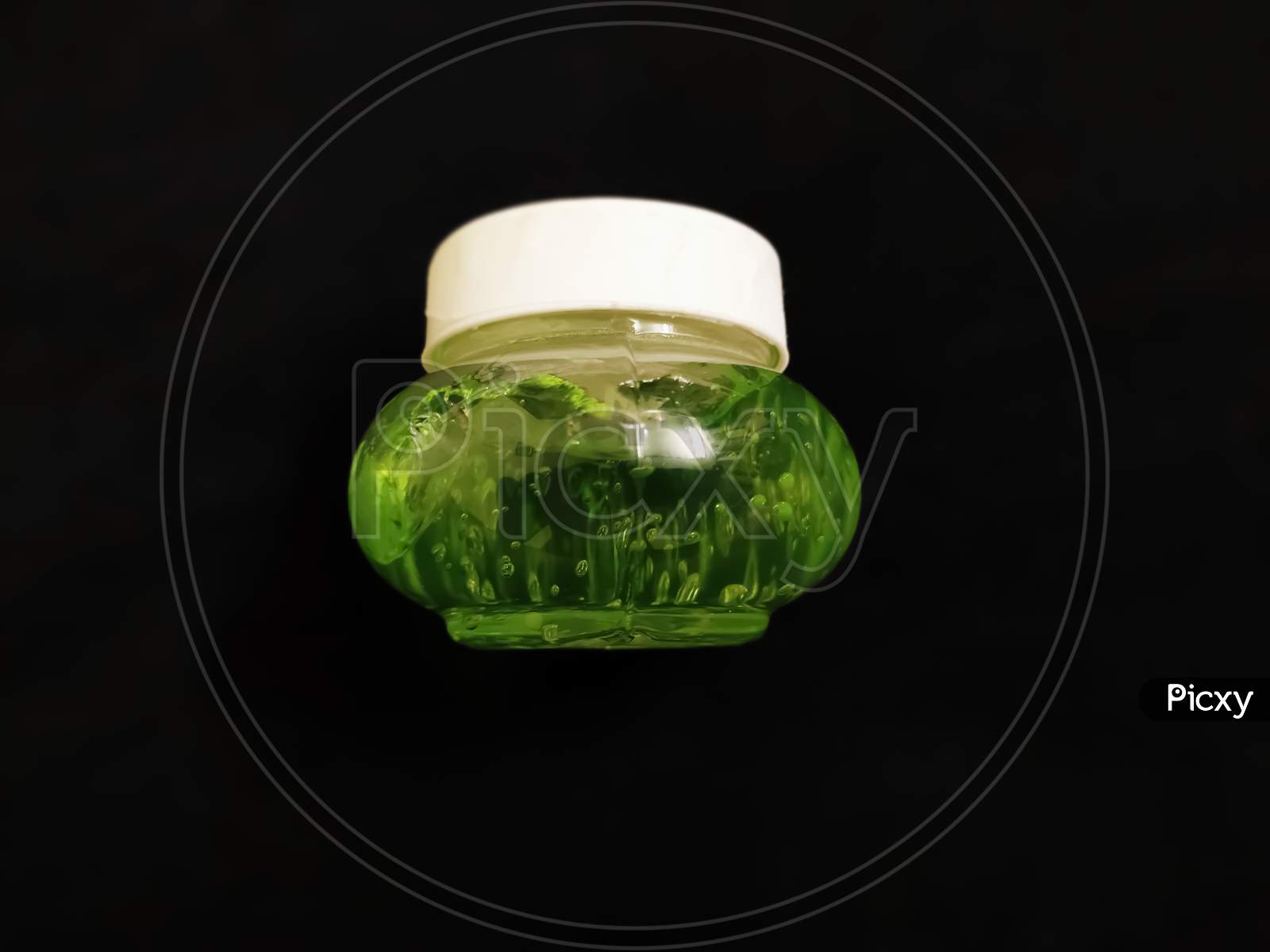 Aloe Vera gel in glass jar with black background