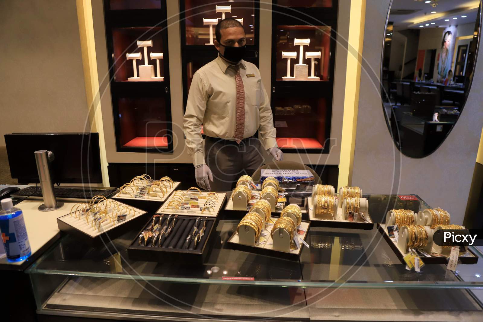 A Sales Man Arranges Jewellery At A Shop After  Authorities Allowed Shopkeepers To Open Their Establishments With Certain Restrictions During Coronavirus or COVID-19 Pandemic in Prayagraj, May 20,2020