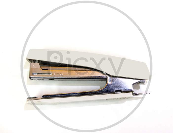 cream color stapler isolated on a white background.