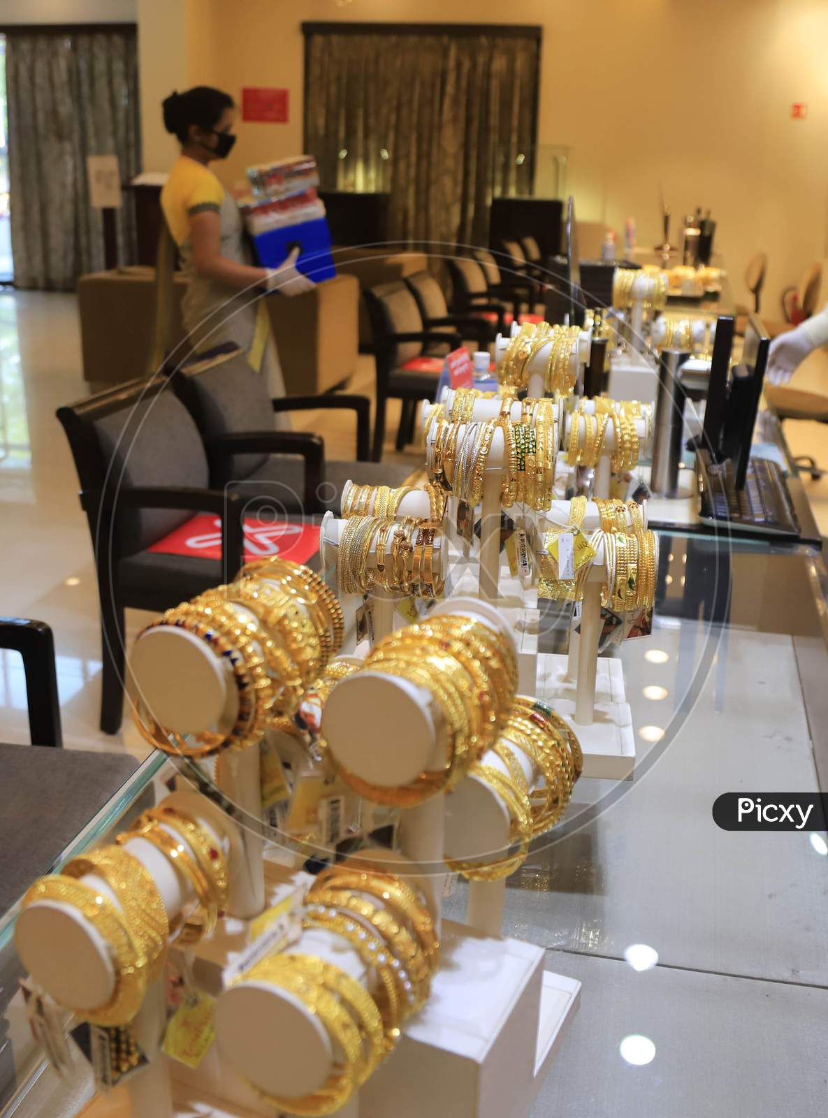 A Sales Girl Arranges Jewellery At A Shop After  Authorities Allowed Shopkeepers To Open Their Establishments With Certain Restrictions During Coronavirus or COVID-19 Pandemic in Prayagraj, May 20,2020