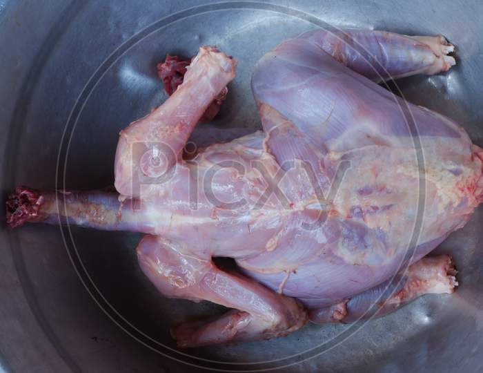 fresh full chicken meat on the pot ,ready to cook,raw chicken