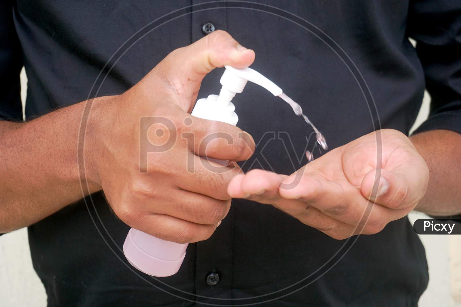 man applying sanitizer to hands