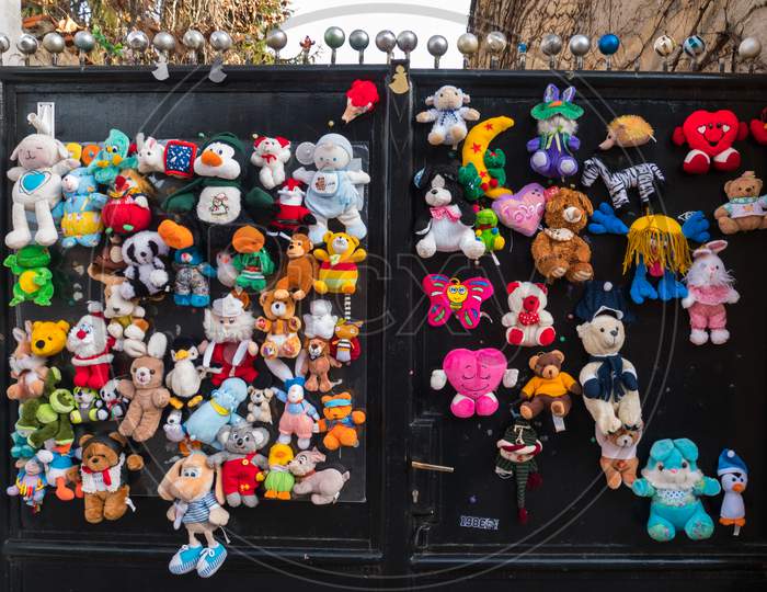Different Plush Toys Glued On A Fence