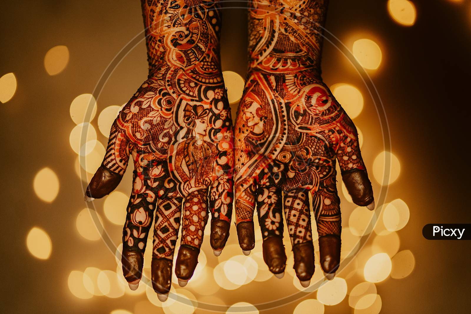 Mehndi Applied to Indian Bride with bokeh in background