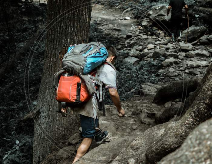 Man hiking with two bag packs