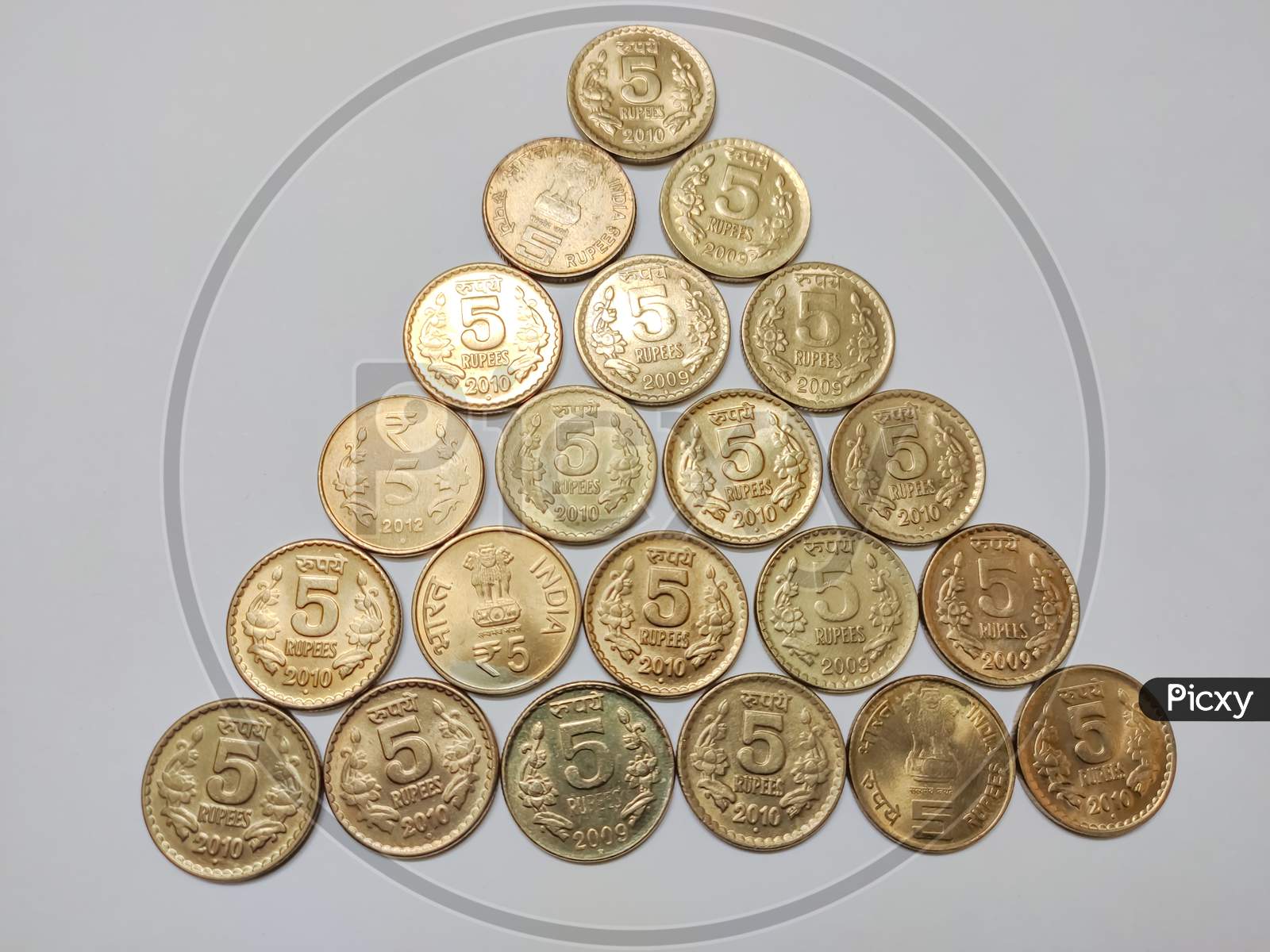 Pyramid of Indian five rupee coins against white background. Stack of Indian 5 rupee coins isolated on white background