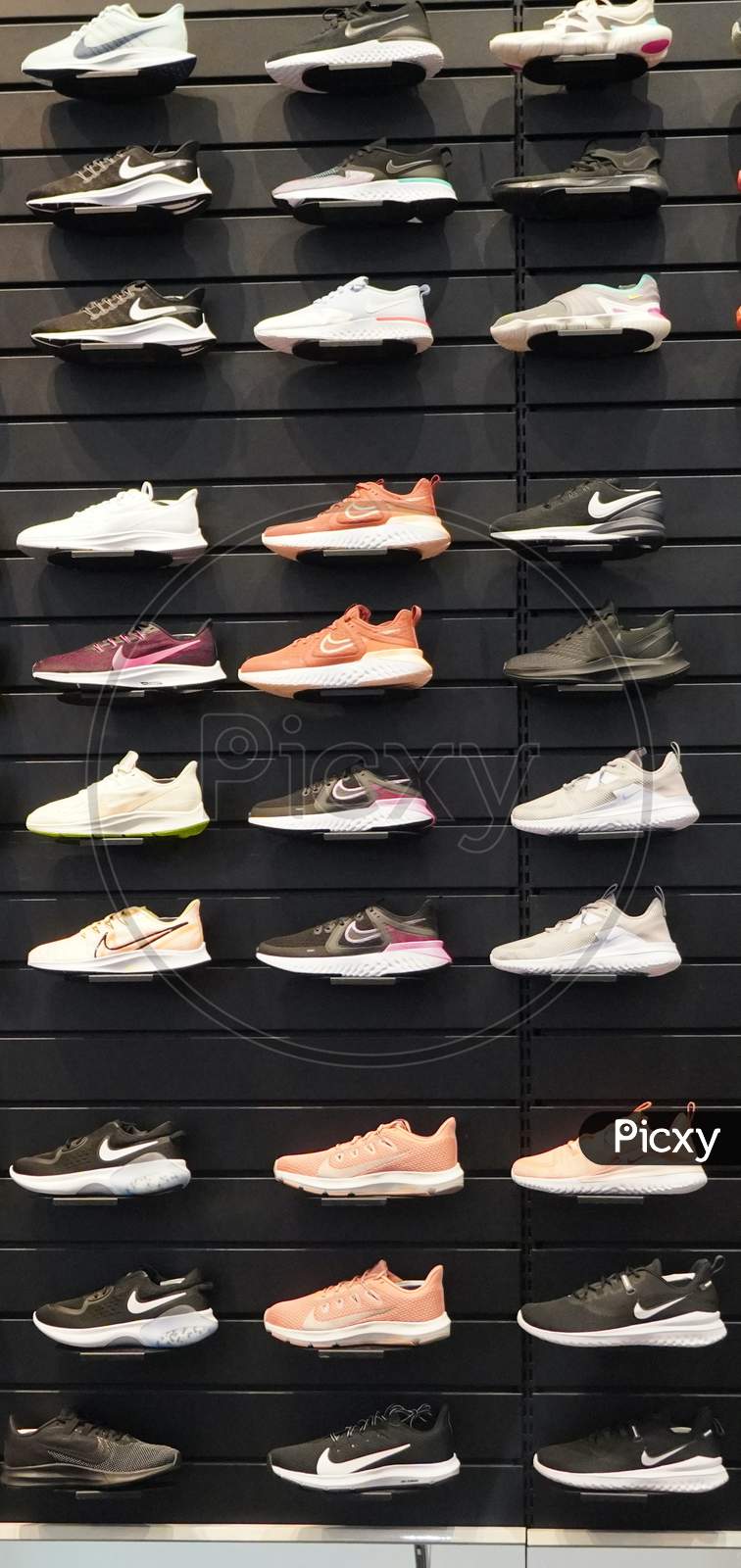 Image of Shop Display Of A Lot Of Sports Shoes On A Wall. A View Of A ...