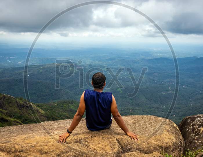 Man Isolated Sitting On Hilltop Felling The Nature