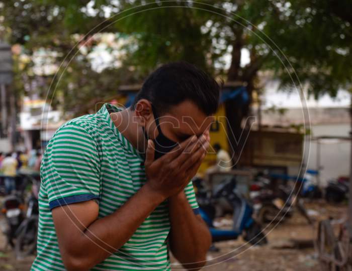 Bharuch, Gujarat/India - March 20, 2020: An Indian men feeling sick, coughing, wearing protective mask against transmissible infectious diseases and as protection against Covid-19 Corona virus.