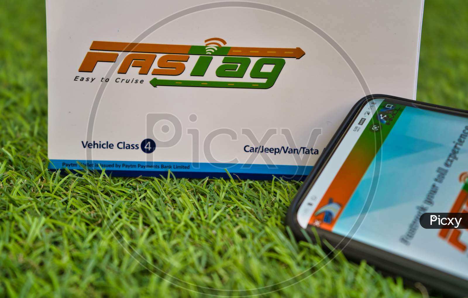 Fast Tag On Green Grass With A Mobile Phone Logged Into Fast Tag Website.
