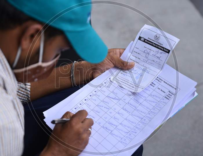 A Cyberabad Police volunteer registers Migrant workers details to issue them a pass to travel free to their native states on Shramik Special Trains during an extended lockdown amid coronavirus fears, Hyderabad, May 19,2020.