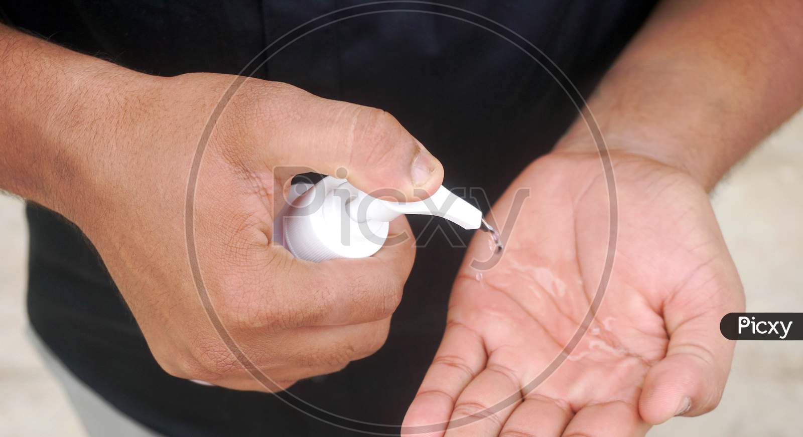 man applying sanitizer to hands
