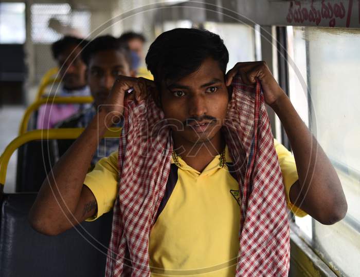 Migrant workers wait in a bus to be carried to Secunderabad Railway Station