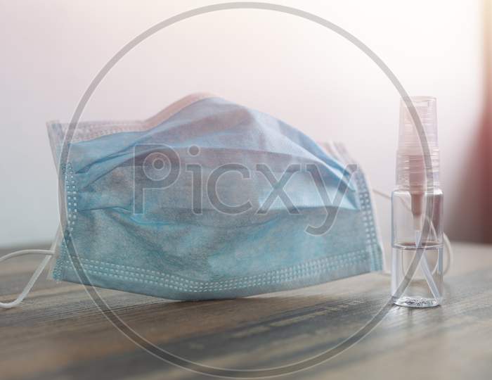 Close up of a surgical face mask and alcohol during the coronavirus covid-19 quarantine