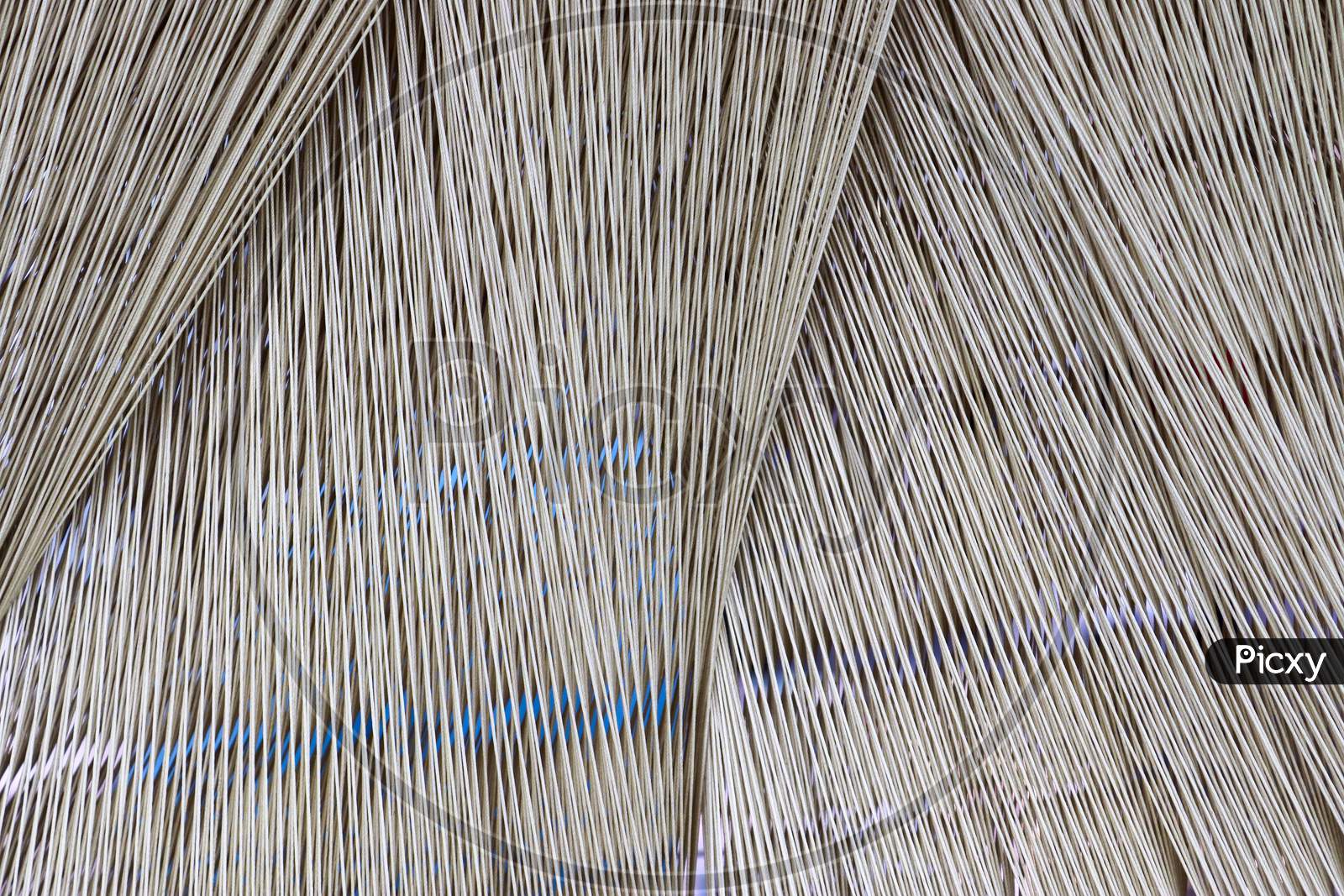 Close up of a lot of threads in a weaving machine called a loom