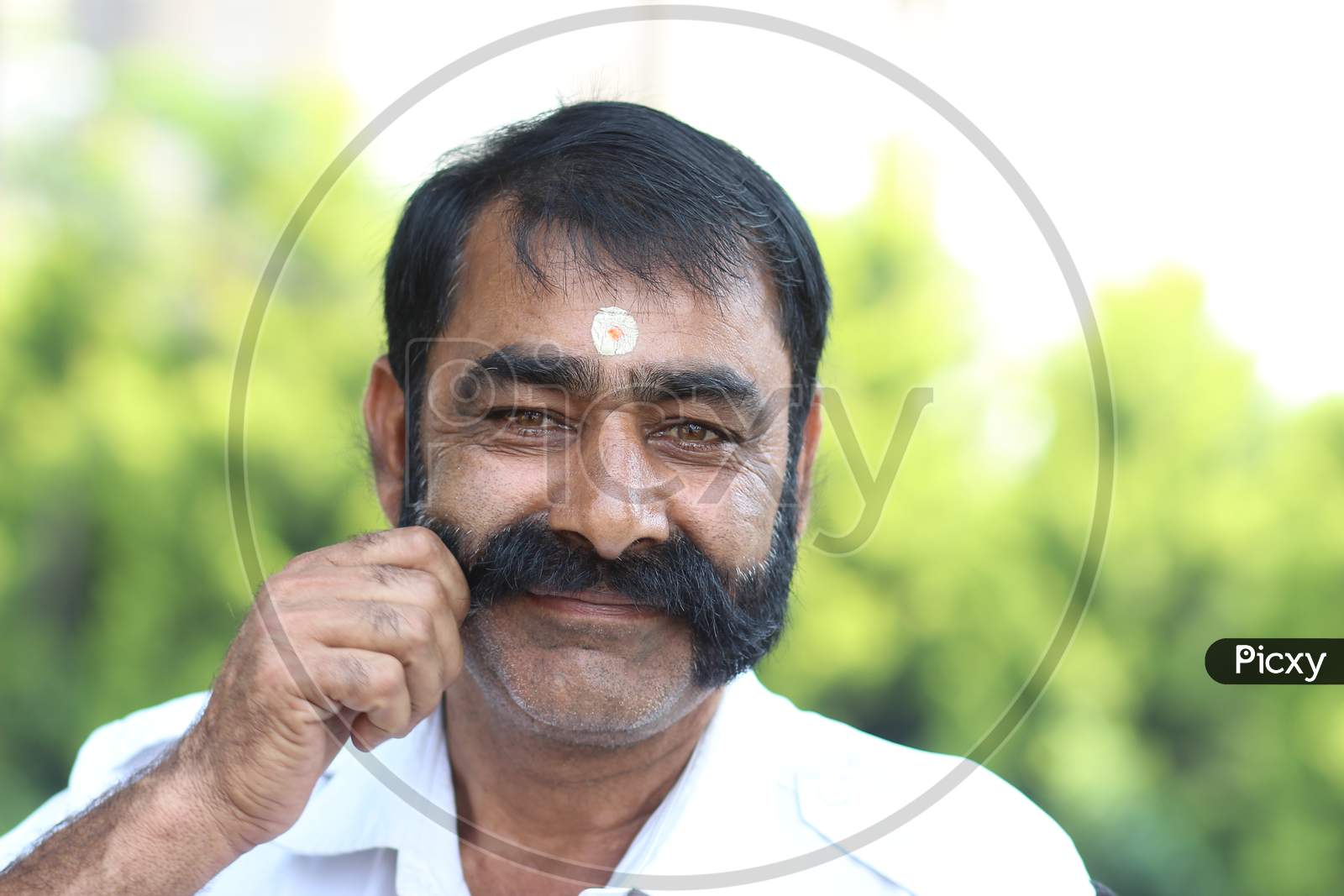 Indian man holding his mustache