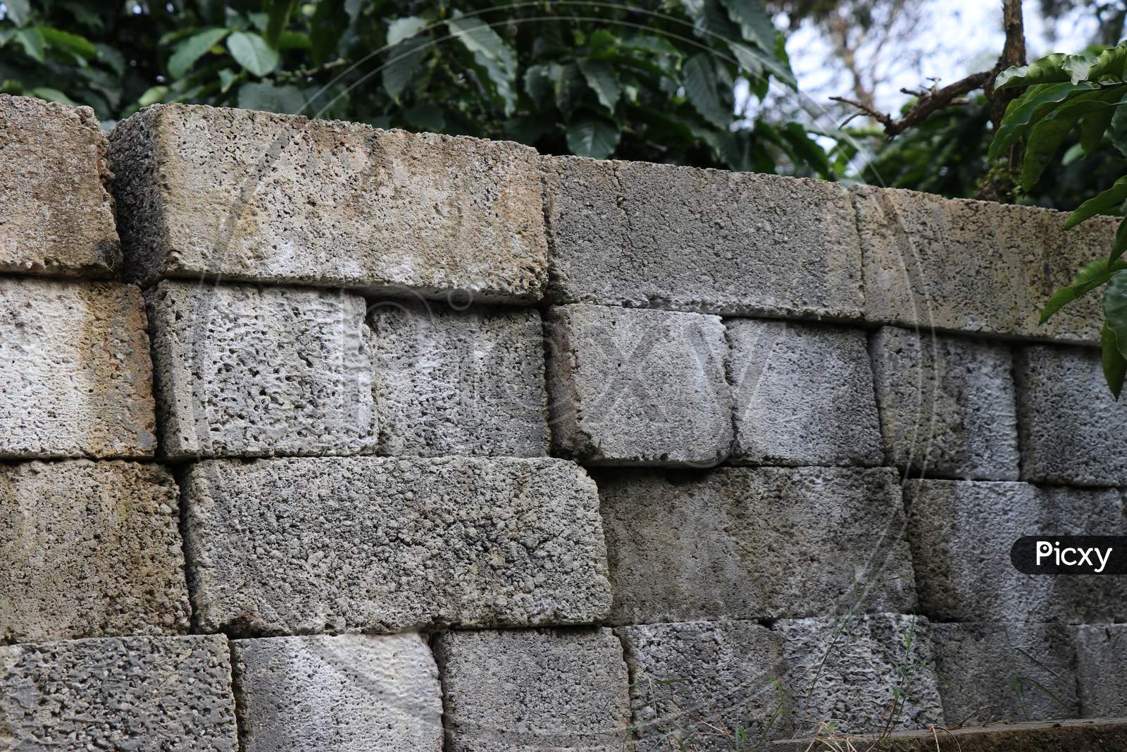 Cement Bricks Arranged In Wall Form With Nature Background