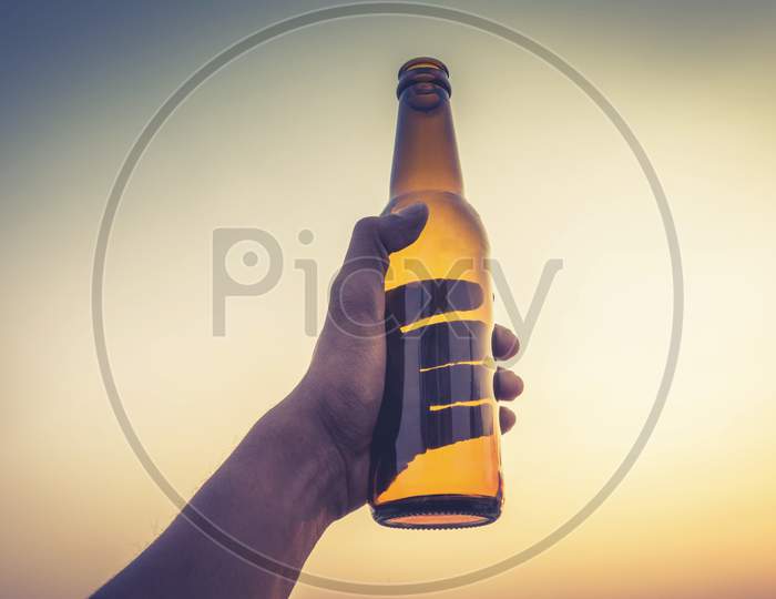 hand holding beer bottle