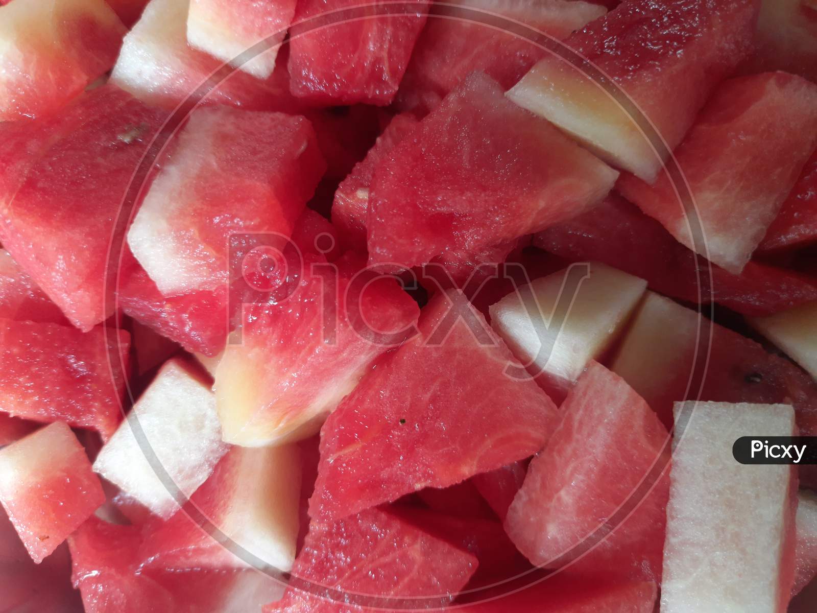watermelon with slices on red background.