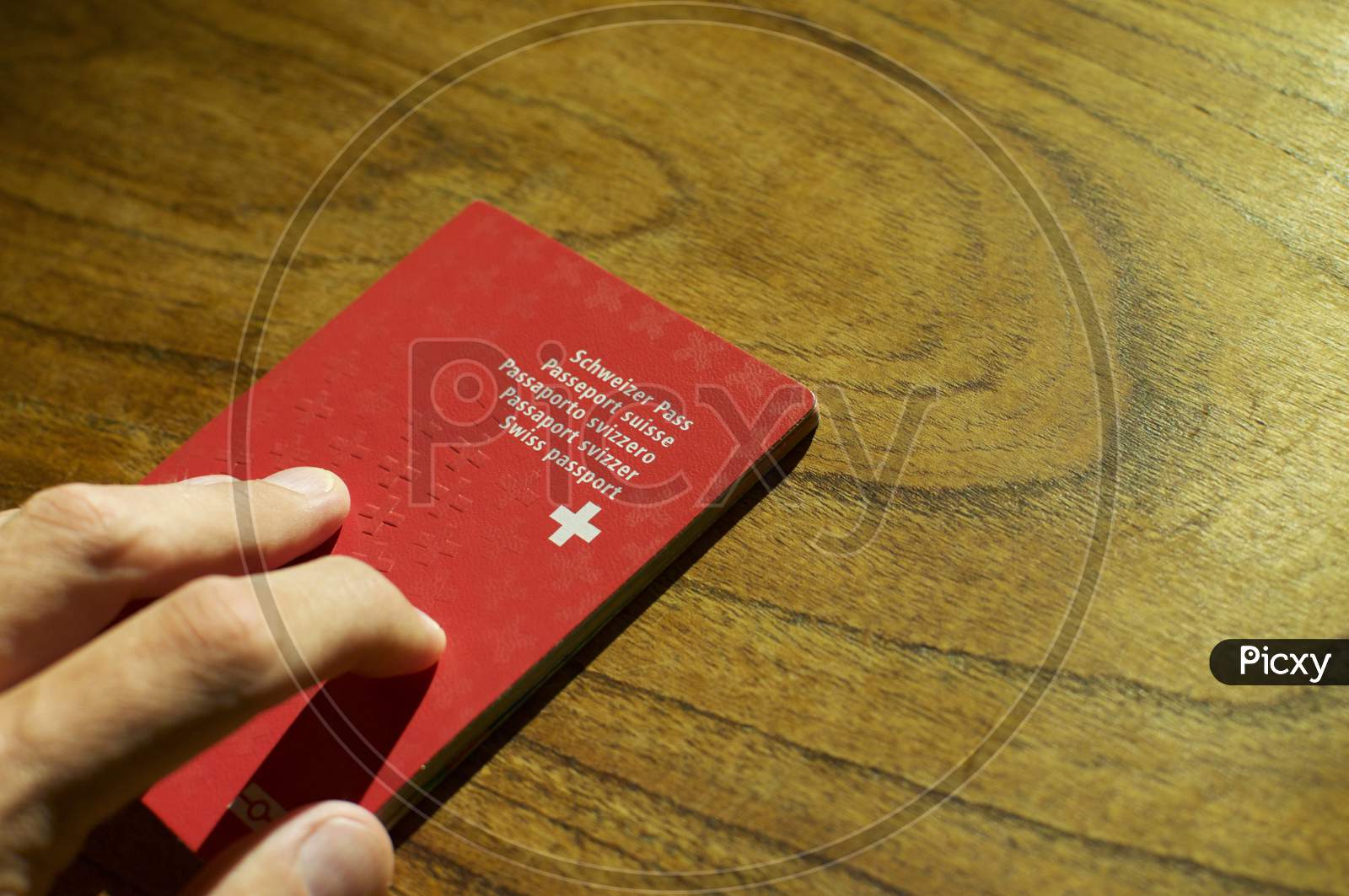 Single Swiss Passport On A Wooden Table