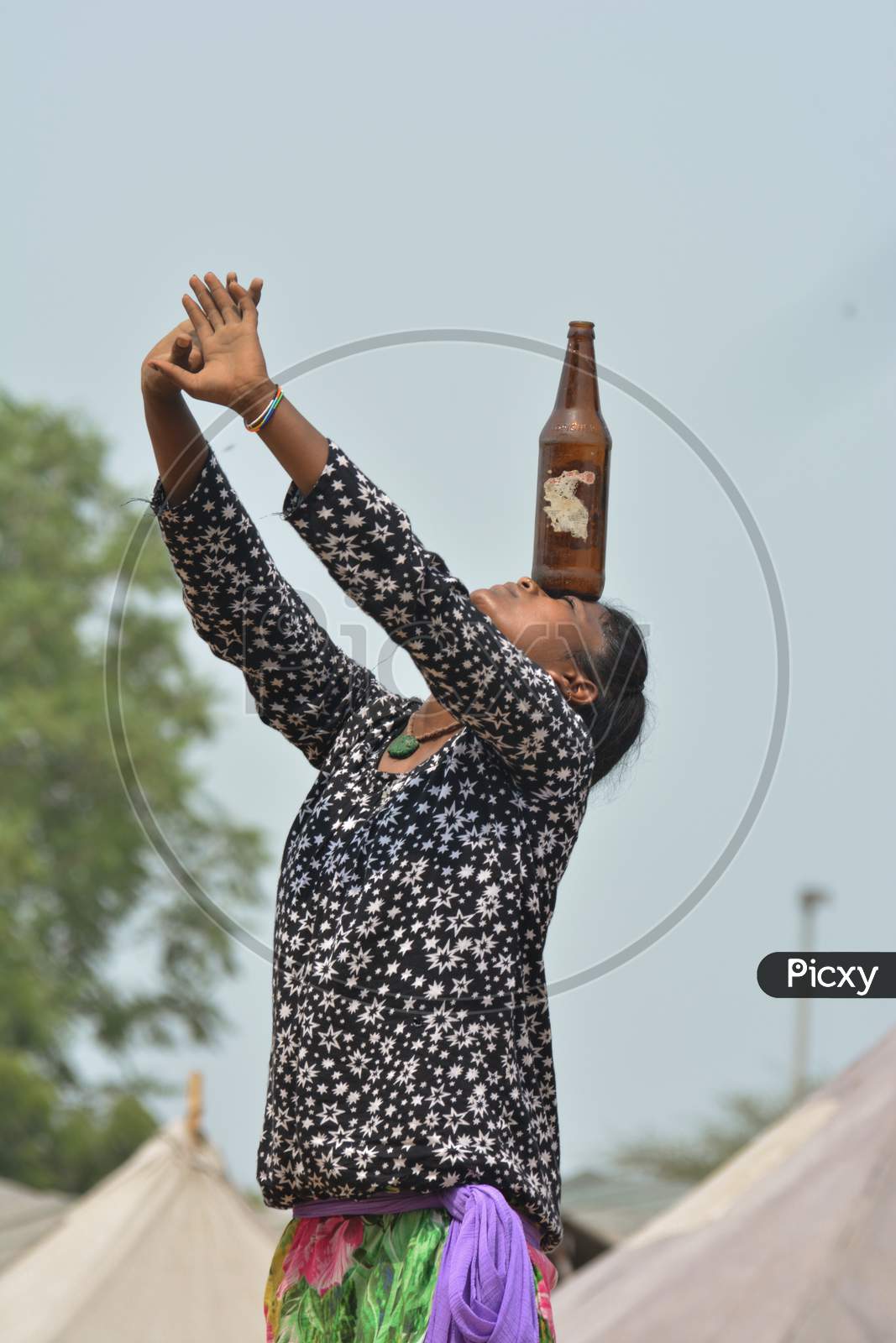 Girl Balancing Bottle On Head Performing Balancing Trick In Public For Earning Money